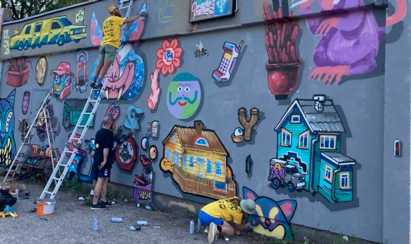 Street artists doing graffiti jam at Stencibility festival in Tartu